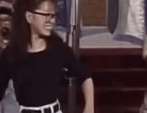 Girl In Glasses And Black Shirt At Door GIF