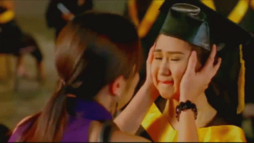 Girl In Graduation Cap And Gown Being Comforted GIF