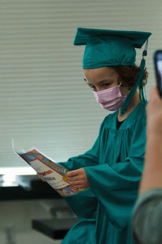 Girl In Graduation Cap And Gown Holding Certificate GIF