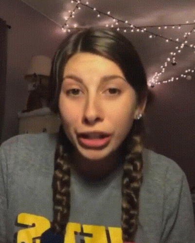 Girl in Gray Shirt with Yellow Letter U