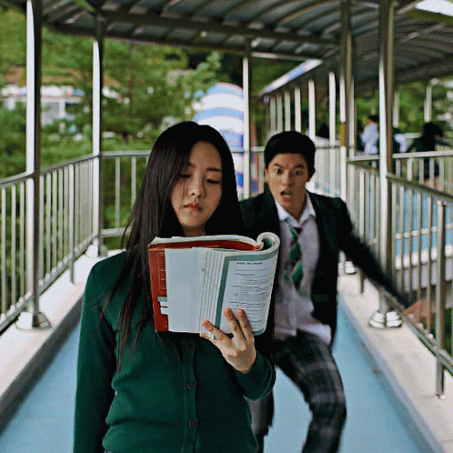 Girl in Green Cardigan Holding Book Saying Physics