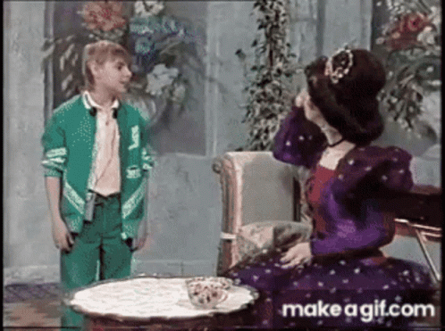 Girl in Green Jacket Next to Woman in Purple Dress