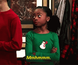 Girl in Green Shirt With Snowman Saying Mhmmm