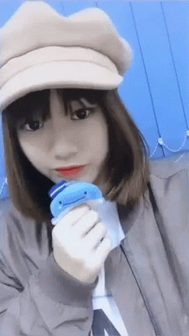 Girl In Hat Holding Blue Toy GIF