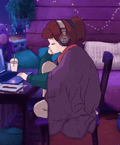 Girl in Headphones at Desk with Laptop