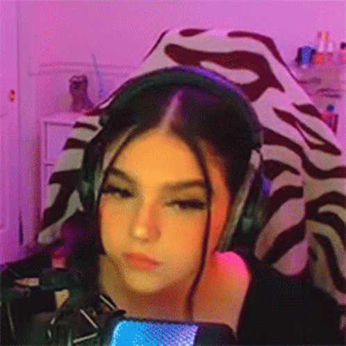 Girl in Headphones at Microphone Looking at Camera