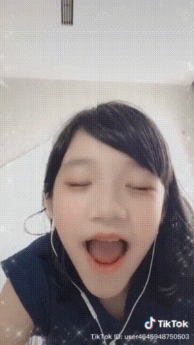 Girl in Headphones Making Funny Face