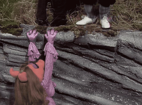Girl in Pink Costume With Horns Reaching Up