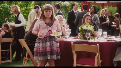 Girl in Pink Dress Holding Food