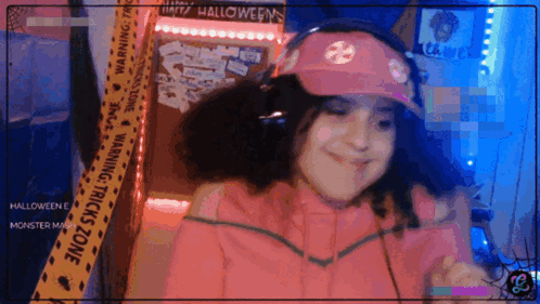 Girl In Pink Hat And Headphones In Front Of Halloween Warning Tape GIF