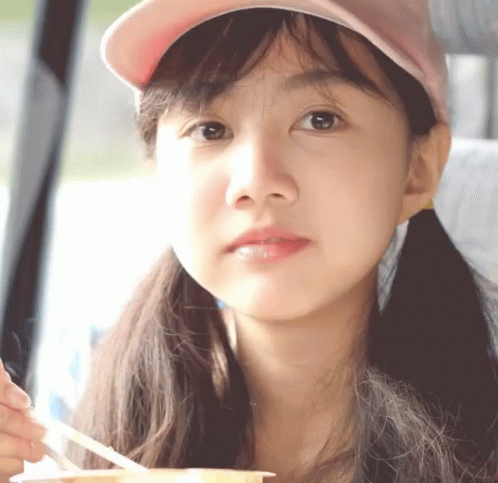 Girl In Pink Hat Holding Spoon GIF