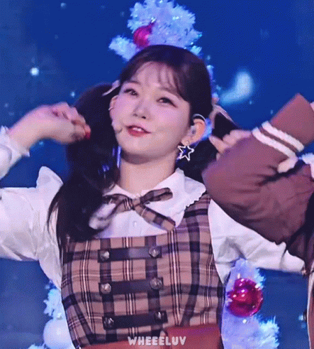 Girl In Plaid Dress Holding Pigtails GIF