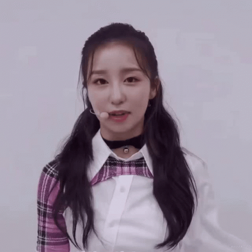 Girl in Plaid Shirt and Choker Looking at Camera