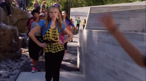 Girl in Plaid Shirt in Front of Olympics Wall