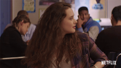Girl In Plaid Shirt Sits In Classroom With Netflix Logo GIF