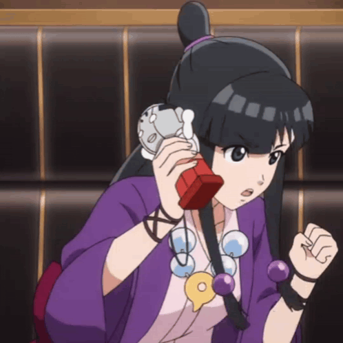 Girl in Purple Shirt Talking on Red Phone