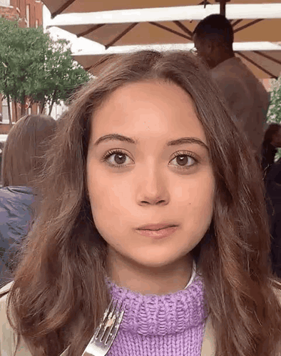 Girl in Purple Sweater Holding Fork