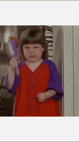 Girl in Red and Purple Dress Holding Toothbrush