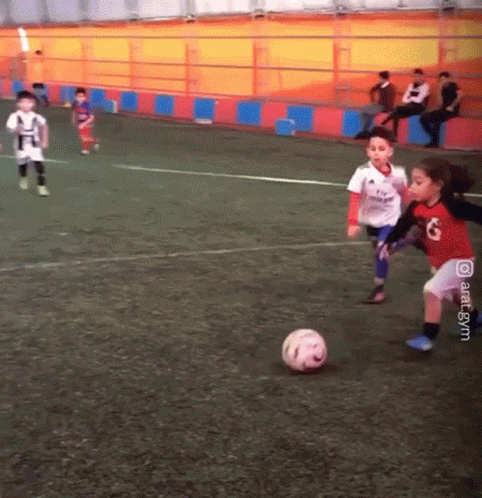 Girl in Red and White Jersey Number 8 Kicking Soccer Ball