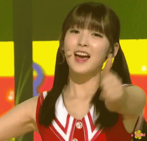 Girl in Red and White Uniform Giving Thumbs Up