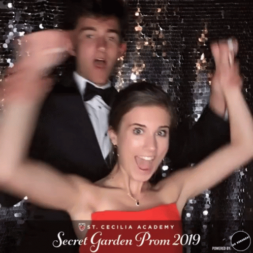 Girl in Red Dress Posing with Man in Tuxedo