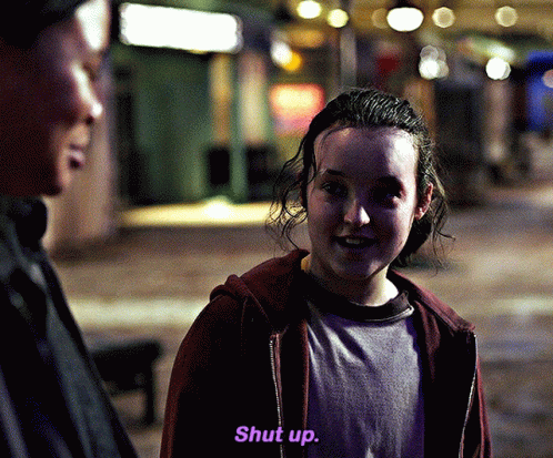 Girl in Red Hoodie Saying Shut Up in Purple Letters
