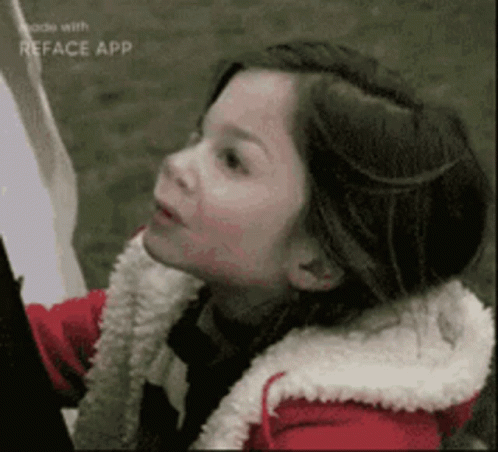 Girl in Red Jacket and White Sweater Looking Up