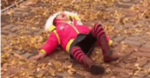 Girl in Red Jacket Lying in Leaves