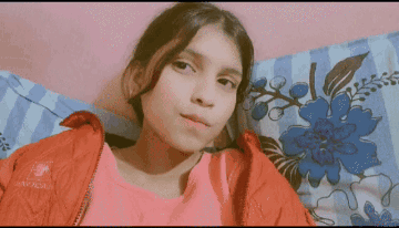 Girl in Red Jacket Lying on Bed