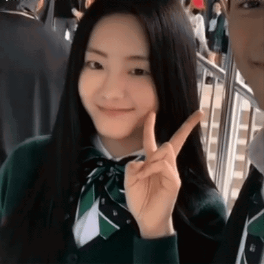 Girl in School Uniform Giving Peace Sign