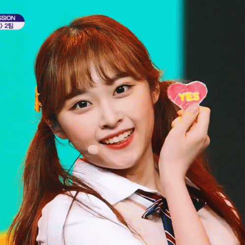 Girl In School Uniform Holding Yes Heart GIF
