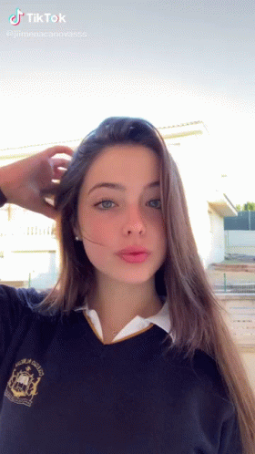 Girl in School Uniform Taking Selfie Hand in Hair