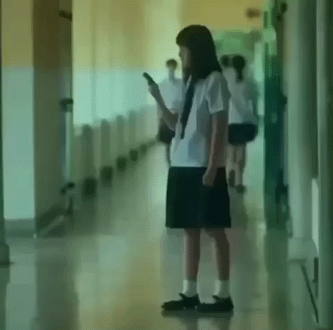 Girl in School Uniform Using Cell Phone