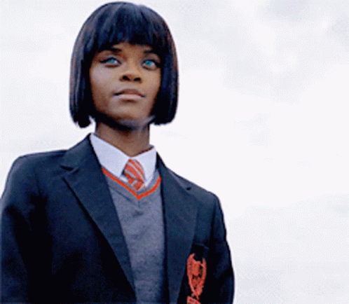 Girl in School Uniform With Badge Saying A