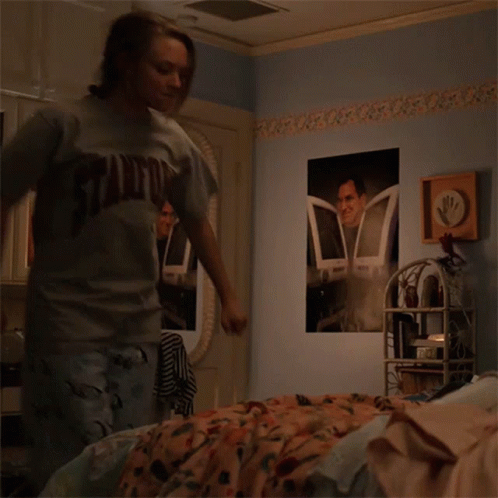 Girl in Stanford Shirt Standing in Bedroom