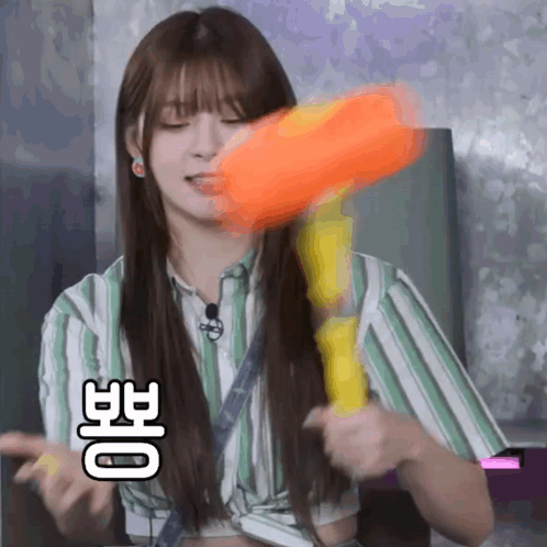 Girl In Striped Shirt Holding Water Gun GIF