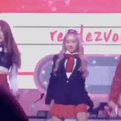 Girl in Suit and Red Skirt Dancing on Stage in Front of Crowd