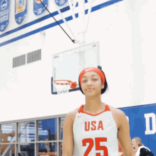 Girl in USA 25 Jersey in Front of Basketball Net