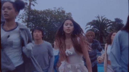 Girl in White Dress Dancing with Group