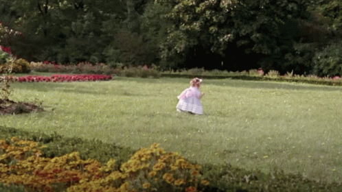 Girl In White Dress Runs In Grassy Field GIF