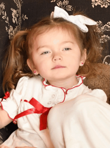 Girl in White Dress with Red Trim