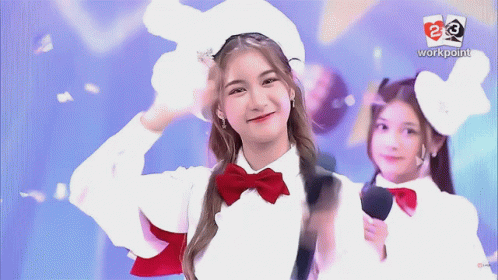 Girl in White Hat and Red Bow Tie Smiling in Front of Workpoint Logo