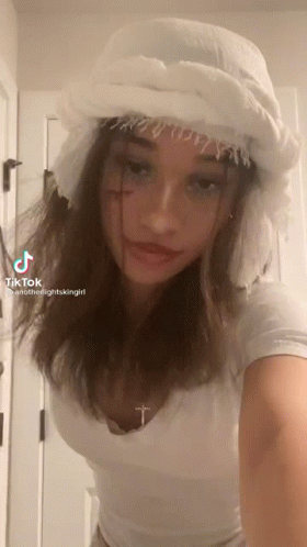 Girl in White Hat With Cross on Neck