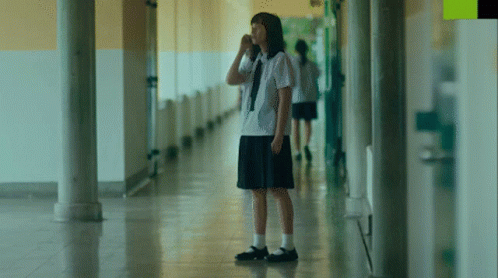 Girl in White Shirt and Black Skirt Hallway