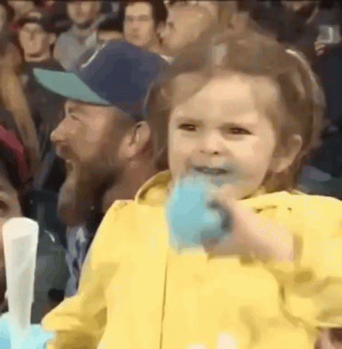 Girl in Yellow Jacket Eating Cotton Candy