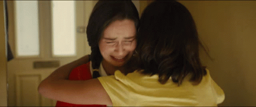 Girl in Yellow Shirt Hugging Girl in Red Shirt