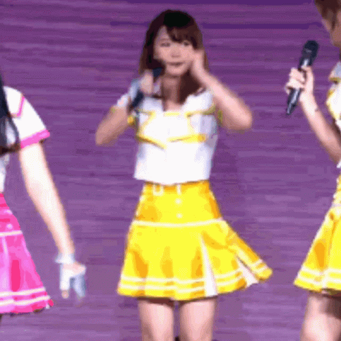 Girl in Yellow Skirt Holding Microphone