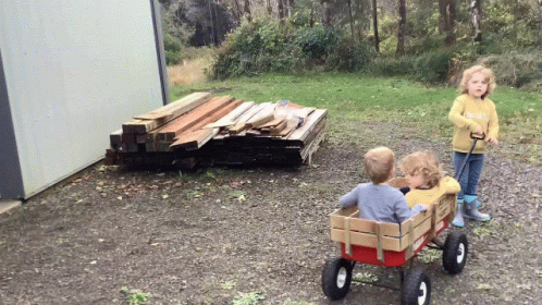 Girl in Yellow Sweater Pulling Wagon