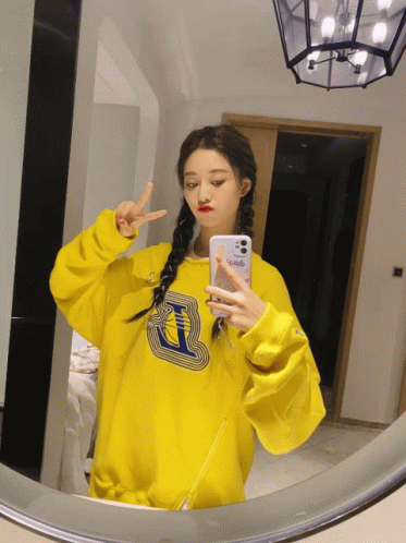 Girl in Yellow Sweatshirt Taking Selfie