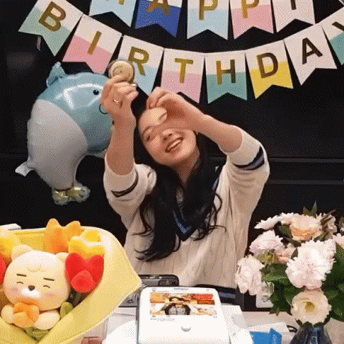 Girl Making Heart Hands Before Birthday Banner